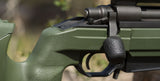 closeup of green rifle with black rifle bolt