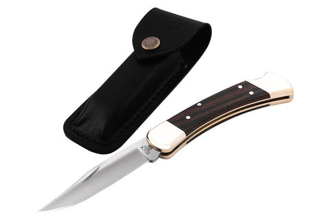 Buck 110 and sheath on white background 